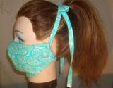 A Personal Care Boutique Face Mask cotton handsewn in California limes on turquoise